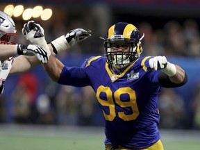 FILE - In this Feb. 3, 2019, file photo, Los Angeles Rams Aaron Donald (99) rushes against the New England Patriots during NFL Super Bowl 53 in Atlanta. Two-time reigning defensive player of the year Aaron Donald is always searching for out-of-the-box ways to improve his game. That's why the Rams defensive lineman trained with knives again this offseason. That's right, knives, of the plastic variety, of course, in order to improve his eye-hand coordination. His real driving force? That loss to the New England Patriots in the Super Bowl last February.