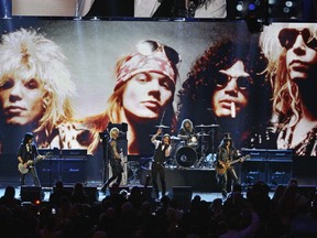 FILE - In this April 15, 2012, file photo, Guns N' Roses performs with singer Myles Kennedy after their induction into the Rock and Roll Hall of Fame in Cleveland. The rock band  is accusing a Colorado brewery of stealing their brand and piggybacking off their fame to sell beer and merchandise. The band filed a trademark infringement lawsuit Thursday, May 9, 2019, against Colorado-based Oskar Blues Brewery, which sells Guns 'N' Rosé beer and merchandise, including bandannas the group says is uniquely associated with singer Axl Rose.