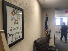 In this photo taken Friday, May 24, 2019, is the entrance to the Wyoming Department of Health headquarters office in Cheyenne, Wyo.  Legal representatives of dozens of Wyoming State Hospital patients say serious problems persist at the state Health Department facility four years after an incapacitated woman was left on a dayroom couch for over 24 hours without food, water or bathroom use. Department officials say major renovations and other improvements will improve conditions.
