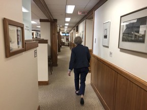 In this May 10, 2019 photo, Sergeant at Arms Leta Edwards of the Oregon Senate searches for Republican senators, who have been dodging the Senate to prevent it from convening in Salem, Ore. Edwards was dispatched to hunt for the GOP senators by the Senate president in order to reach a quorum. Republican senators began their walkout on Tuesday, May 7, 2019, to protest an education-funding bill that imposes a tax on some businesses.