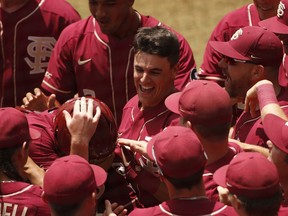 Florida State's Tim Becker (37) celebrates with teammates after hitting a twp-run home run against Florida Atlantic at the NCAA college baseball regional tournament in Athens, Ga., Friday, May 31, 2019.