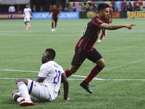 Atlanta United midfielder Pity Martinez, right, reacts to scoring a goal past Orlando City defender Kamal Miller for a 1-0 lead in a MLS soccer match on Sunday, May 12, 2019, in Atlanta.