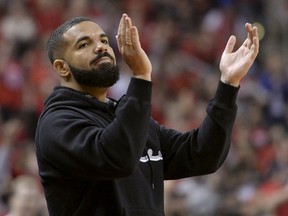 Toronto-born performer Aubrey "Drake" Graham cheers from courtside during first half NBA Eastern Conference finals action between the Toronto Raptors and the Milwaukee Bucks, in Toronto on Saturday, May 25, 2019.