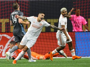 Atlanta United's defender Franco Escobar reacts after scoring a goal against Minnesota United as Josef Martinez, right celebrates with him during the first half of an MLS soccer match Wednesday, May 29, 2019, in Atlanta.