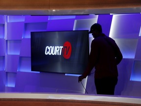 In this Thursday, May 2, 2019, photo, a man works to ready the Court TV set, in Atlanta. The channel for legal junkies that thrived during the trial-crazy 1990s comes back from the dead after more than a decade, on Wednesday, May 8, 2019, amid a true-crime craze that its backers hope will launch it into a long new life.
