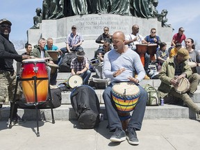 People play drums during the Tam-Tams festival in Montreal, Sunday, May 12, 2019.