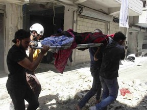 ADDS DATE --This photo provided by the Syrian Civil Defense White Helmets, which has been authenticated based on its contents and other AP reporting, shows Syrians carrying an injured person on a stretcher after an airstrike by Syrian government forces, in the town of Ariha, in the northwestern province of Idlib, Syria, Monday, May 27, 2019. Syria's White Helmets say at least six people were killed and 10 remain under rubble following government air raids on a town in the rebel's last stronghold. (Syrian Civil Defense White Helmets via AP)