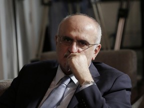 Lebanese Finance Minister Ali Hassan Khalil listens to Lebanese Information Minister Jamal Jarrah while speaks to journalist at the Government House in Beirut, Lebanon, Friday, May 24, 2019. Jarrah says the government has agreed on a 2019 budget, wrapping up weeks of haggling over an austerity budget that aims to cut public spending and reduce the deficit.