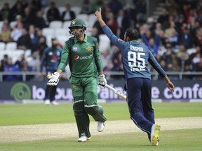 Pakistan's Babar Azam, left, is run out by England's Adil Rashid, left, during the Fifth One Day International cricket match between England and Pakistan at Emerald Headingley in Leeds, England, Sunday, May 19, 2019.