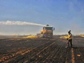 This Tuesday, May 28, 2019 photo, provided by the Syrian Civil Defense White Helmets, which has been authenticated based on its contents and other AP reporting, shows Syrian White Helmet civil defense workers trying to extinguish a fire in a field of crops, in Kfar Ain, the northwestern province of Idlib, Syria. Crop fires in parts of Syria and Iraq have been blamed on defeated Islamic State group militants in the east seeking to avenge the group's losses, and on Syrian government forces in the west battling to rout other armed groups there. (Syrian Civil Defense White Helmets via AP)