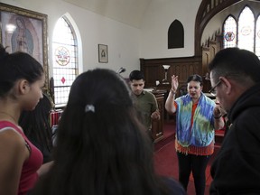 Pastor Jacobita Cortes offers a prayer at Lincoln United Methodist Church in Chicago on Wednesday, May 15, 2019, for Marlen Ochoa-Uriostegui, a pregnant teen who was reported missing on April 23, 2019. Marlen Ochoa-Uriostegui who had gone to a Chicago home in response to a Facebook offer of free baby clothes was strangled and her baby cut from her womb, police and family members said.