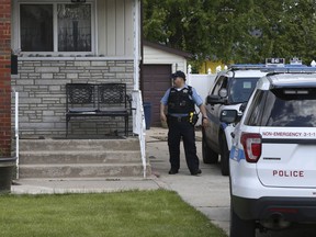 CORRECTS VICTIM'S LAST NAME TO OCHOA-LOPEZ INSTEAD OF OCHOA-URIOSTEGUI - Chicago police watch over a home in Chicago, Wednesday, May 15, 2019, where Marlen Ochoa-Lopez was found strangled and her baby cut from her womb. Police and family members said Ochoa-Lopez went to the home in response to a Facebook offer of free baby clothes.