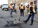 Infrastructure Minister François-Philippe Champagne, right, repairs a pothole in Sudbury, Ont. on March 28, 2019. In a statement, he said the infrastructure program has seen 