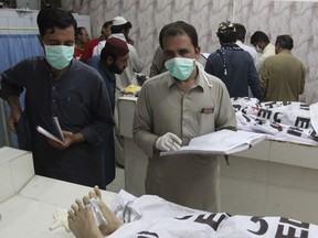 Pakistan hospital staff collect information of alleged terrorists killed by security forces, at mortuary in Quetta, Pakistan, Thursday, May 16, 2019. Pakistani police say security forces acting on intelligence raided a militant hideout in the town of Mastung in southwestern Baluchistan province, triggering a shootout that killed many suspects.