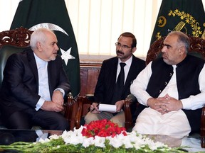 In this photo released by the National Assembly, Iranian Foreign Minister Mohammad Javad Zarif, left, meets Speaker National Assembly Asad Qaiser in Islamabad, Pakistan, Friday, May 24, 2019. Zarif is in Pakistan Friday on a critically timed visit amid a crisis between Tehran and Washington and ahead of next week's emergency Arab League meeting called by Saudi Arabia as regional tensions escalate. (Pakistan National Assembly via AP)