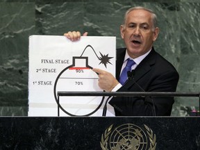 FILE - In this Sept. 27, 2012 file photo, Israeli Prime Minister Benjamin Netanyahu shows an illustration as he describes his concerns over Iran's nuclear ambitions during his address to the 67th session of the United Nations General Assembly at U.N. headquarters. Netanyahu has been a vocal critic of Iran over the years, accusing the Islamic Republic of sinister intentions at every opportunity. But the outspoken Israel leader has remained uncharacteristically quiet throughout the current crisis between the U.S. and Iran.