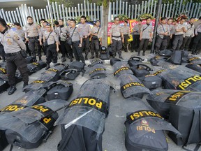 Riot police are deployed in anticipation of protests outside the General Election Supervisory Board building in Jakarta, Indonesia, Tuesday, May 28, 2019. Four top Indonesian officials, including two Cabinet ministers and the national spy chief, were targeted for assassination as part of a plot possibly linked to last week's election riots, police said Tuesday.