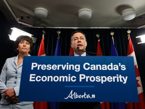 Premier Jason Kenney (right) speaks beside Energy Minister Sonya Savage about Bill 12, the turn-off-the-taps legislation, during a press conference in the media room in the Alberta Legislature in Edmonton, on Wednesday, May 1, 2019.