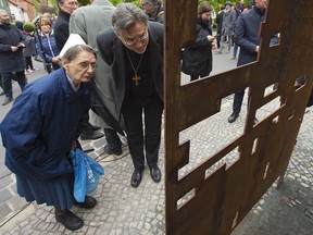 People look to an installation during the official inauguration of a memeorial in remembrance of the Institute for the Study and Elimination of Jewish Influence on German Church Life during the Third Reich in Eisenach, Germany, Monday, May 6, 2019. The Institute was a cross-church establishment by some German Protestant churches during the Third Reich, founded at the instigation of the German Christian movement. It was set up in Eisenach under Walter Grundmann in 1939.