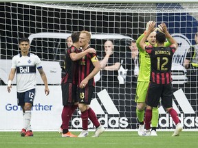 Members of the Atlanta United celebrate their 1-0 win over the Vancouver Whitecaps following the second half of MLS soccer action in Vancouver, B.C., Wednesday, May, 15, 2019.