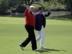 President Donald Trump walks with Japanese Prime Minister Shinzo Abe before playing a round of golf at Mobara Country Club, Sunday, May 26, 2019, in Chiba, Japan.