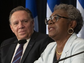 Regine Laurent, right, president of a commission looking into child protection services, speaks at a news conference, in Quebec City on Thursday, May 30, 2019. Quebec Premier Francois Legault, left, looks on. The commission was prompted by the recent death of a seven-year-old girl in Granby.