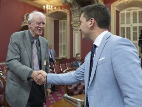 Charles Taylor, left, co-author of the Bouchard-Taylor report, is greeted by Quebec Minister of Immigration, Diversity and Inclusiveness Simon Jolin-Barrette as he arrives at a legislature committee studying a bill on secularism, Tuesday, May 7, 2019 at the legislature in Quebec City.