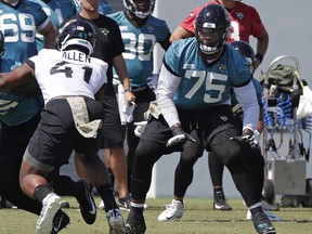 Jacksonville Jaguars offensive lineman Jawaan Taylor (75) looks to block Jacksonville Jaguars defensive end Josh Allen (41) during an NFL football practice, Tuesday, May 21, 2019, in Jacksonville, Fla.