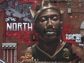 A mural painted on the side a brick building showing Toronto Raptors' Kawhi Leonard in Toronto.