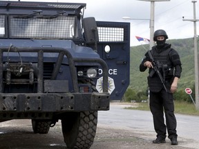 Kosovo police special unit members secure the area near the village of Cabra, north western Kosovo, during an ongoing police operation on Tuesday, May 28, 2019.