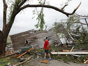 Joe Armison looks over his destroyed barn after a tornado struck the outskirts of Eudora, Kan., Tuesday, May 28, 2019.