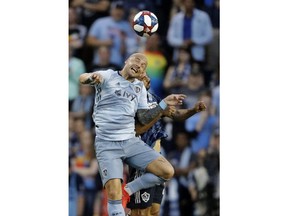 Sporting Kansas City midfielder Yohan Croizet, front, beats LA Galaxy defender Giancarlo Gonzalez to the ball during the first half of an MLS soccer match Wednesday, May 29, 2019, in Kansas City, Kan.