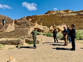 This photo provided by the Navajo Nation, Interior Secretary David Bernhardt, third from left, tours Chaco Culture National Historical Park about 95 miles northeast of Gallup, N.M., Tuesday, May 28, 2019. U.S. Sen. Martin Heinrich of New Mexico is at Bernhardt's right. Navajo Nation President Jonathan Nez is on the far right.