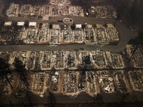 FILE - This Nov. 15, 2018, aerial file photo shows the remains of residences leveled by the Camp wildfire in Paradise, Calif. Pacific Gas & Electric Corp. has received approval to establish a $105 million fund to help survivors of recent California wildfires started by the utility's power lines. A federal judge overseeing PG&E's bankruptcy case approved the utility's "wildfire assistance program" on Wednesday, May 22, 2019.