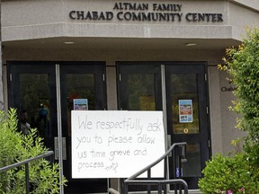 FILE - In this April 29, 2019 file photo, A sign asks for time to grieve at the Chabad of Poway synagogue in Poway, Calif. The gunman who attacked the synagogue last week fired his semi-automatic rifle at Passover worshippers after walking through the front entrance that synagogue leaders identified last year as needing improved security. The synagogue applied for a federal grant to better protect that area. The money, $150,000, was approved in September but only arrived in late March. "Obviously we did not have a chance to start using the funds yet," Rabbi Scimcha Backman told The Associated Press.