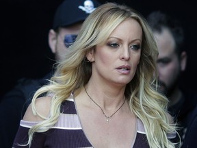 FILE - In this Oct. 11, 2018, file photo, adult film actress Stormy Daniels arrives at the adult entertainment fair "Venus" in Berlin. Daniels has agreed to dismiss a lawsuit that accused her former lawyer of colluding with President Donald Trump's ex-lawyer, Michael Cohen, to have her deny having an affair with Trump. A notice of agreement with Cohen and Daniels' ex-attorney, Keith Davidson, were filed Thursday, May 16, with a Los Angeles court.