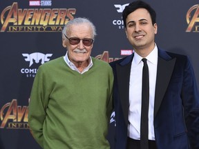 FILE - In this April 23, 2018, file photo, Stan Lee, left, and Keya Morgan arrive at the world premiere of "Avengers: Infinity War" in Los Angeles. Morgan, the former business manager of Lee has been arrested on elder abuse charges involving the late comic book icon. Los Angeles police say  Morgan was taken into custody in Arizona early Saturday, May 25, 2019, on an outstanding arrest warrant. Morgan was charged earlier this month with felony allegations of theft, embezzlement, forgery or fraud against an elder adult, and false imprisonment of an elder adult.