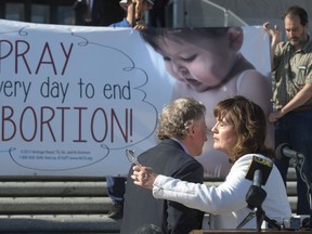 Sen. John Milkovich, D-Shreveport, and Rep. Valarie Hodges, R-Denham Springs, right, embrace after speaking to the media outside the State Capitol, Wednesday, May 29, 2019, in Baton Rouge, La., after the House passed Milkovich's 'fetal heartbeat' bill that would ban abortions at about six weeks of pregnancy, if upheld by the courts, sending it to the governor's desk without exceptions for victims of rape and incest. Hodges handled the bill on the House side for its passage there.