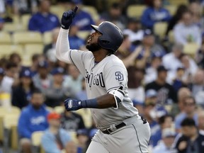 San Diego Padres' Franmil Reyes points skyward after hitting a solo home run against the Los Angeles Dodgers during the first inning of a baseball game Tuesday, May 14, 2019, in Los Angeles.