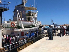 Rescued migrants desembark from the Mare Jonio rescue ship of the Italian NGO Mediterranea Saving Humans as it docked at the port of the Italian island of Lampedusa, southern Italy, Friday, May 10, 2019. According to Mediterranea Saving Humans, some 30 migrants, including two pregnant women and a small child, were rescued a day earlier off the Libyan coast.