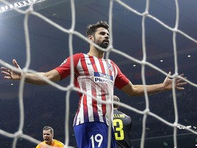 FILE - In this Wednesday, Feb. 20, 2019 file photo, Atletico forward Diego Costa reacts after missing to score during the Champions League round of 16 first leg soccer match between Atletico Madrid and Juventus at Wanda Metropolitano stadium in Madrid. Atletico Madrid says Diego Costa sprained his left ankle in the team's 2-1 loss in a friendly at Beitar Jerusalem on Tuesday May 21, 2019.