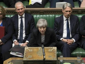 In this image made available by UK Parliament, Britain's Prime Minister Theresa May speaks during Prime Minister's Questions in the House of Commons, London, Wednesday, May 22, 2019. British Prime Minister Theresa May dug in Wednesday against a growing push by both rivals and former allies to remove her from office as her attempts to lead Britain out of the European Union appeared to be headed for a dead end.