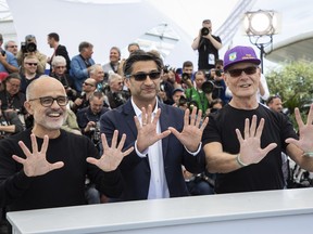 Producer Daniel Arcucci, from left director Asif Kapadia and Fernando Signorini pose for photographers at the photo call for the film 'Diego Maradona' at the 72nd international film festival, Cannes, southern France, Monday, May 20, 2019.