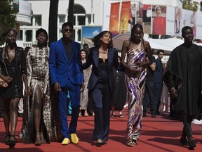 Writer director Mati Diop, fourth from left, poses with cast and crew upon arrival at the premiere of the film 'Atlantique' at the 72nd international film festival, Cannes, southern France, Thursday, May 16, 2019.