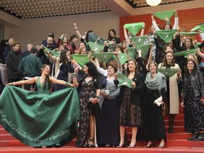 Cast and crew of the film 'Let it be Law' demonstrate for the legalization of abortion in Argentina upon arrival at the premiere of the film 'The Wild Goose Lake' at the 72nd international film festival, Cannes, southern France, Saturday, May 18, 2019.