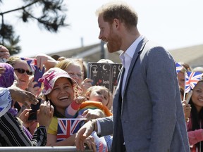 Britain's Prince Harry, The Duke of Sussex meets members of the public as he arrives for a visit to Barton Neighbourhood Centre in Oxford, England Tuesday, May 14, 2019. The centre is a hub for local residents which houses a doctor's surgery, food bank, cafe and youth club.