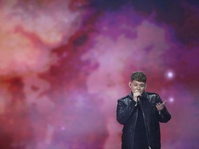 FILE - In this Friday, May 17, 2019 file photo, Michael Rice of Great Britain performs the song "Bigger Than Us" during the 2019 Eurovision Song Contest grand final rehearsal in Tel Aviv, Israel. Britain's Eurovision song "Bigger Than Us" is an even bigger flop than previously thought after its last-placed entry was stripped of five points to correct a math error on Thursday, May 23, 2019.