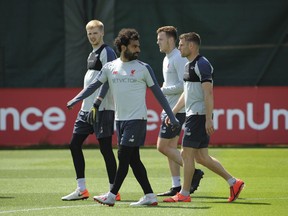 Liverpool's Mohamed Salah, second left, takes part in a training session at the Liverpool soccer team media open day, in Liverpool, England, Tuesday, May 28, 2019, ahead of their Champions League Final soccer match against Tottenham on Saturday in Madrid.