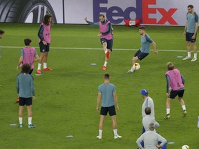 Chelsea players including Gonzalo Higuain, center top, take part in a soccer training session at the Olympic stadium in Baku, Azerbaijan, Tuesday, May 28, 2019. English Premier League teams Arsenal and Chelsea are preparing for the Europa League Final soccer match that takes place in Baku on Wednesday night.