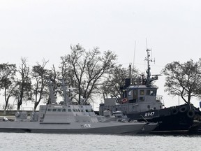 FILE - In this Monday, Nov. 26, 2018 file photo, three Ukrainian ships are docked near the Kerch after been seized on Sunday, in Kerch, Crimea. A U.N. court is considering a legal case brought by Ukraine over the capture of 24 sailors and three naval vessels held by Russia since November. The Hamburg-based International Tribunal for the Law of the Sea began its two-day hearing Friday May 10, 2019. (AP Photo)